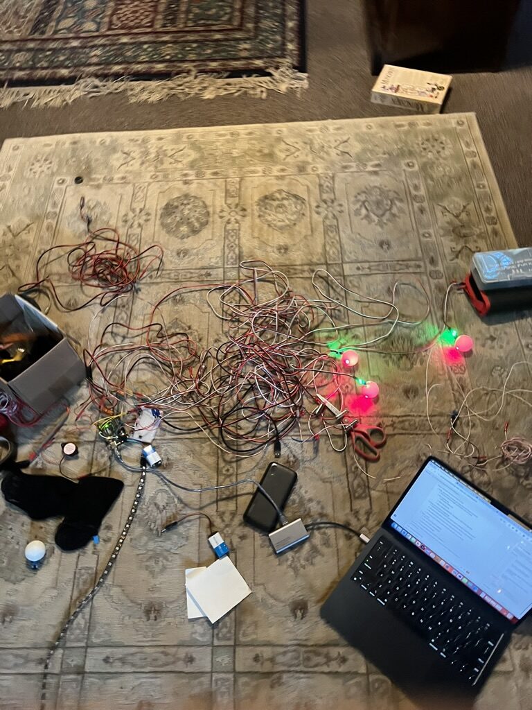 Arduino board wired up with lasers, photosensors, buzzer, and a tangle of small-gauge wire