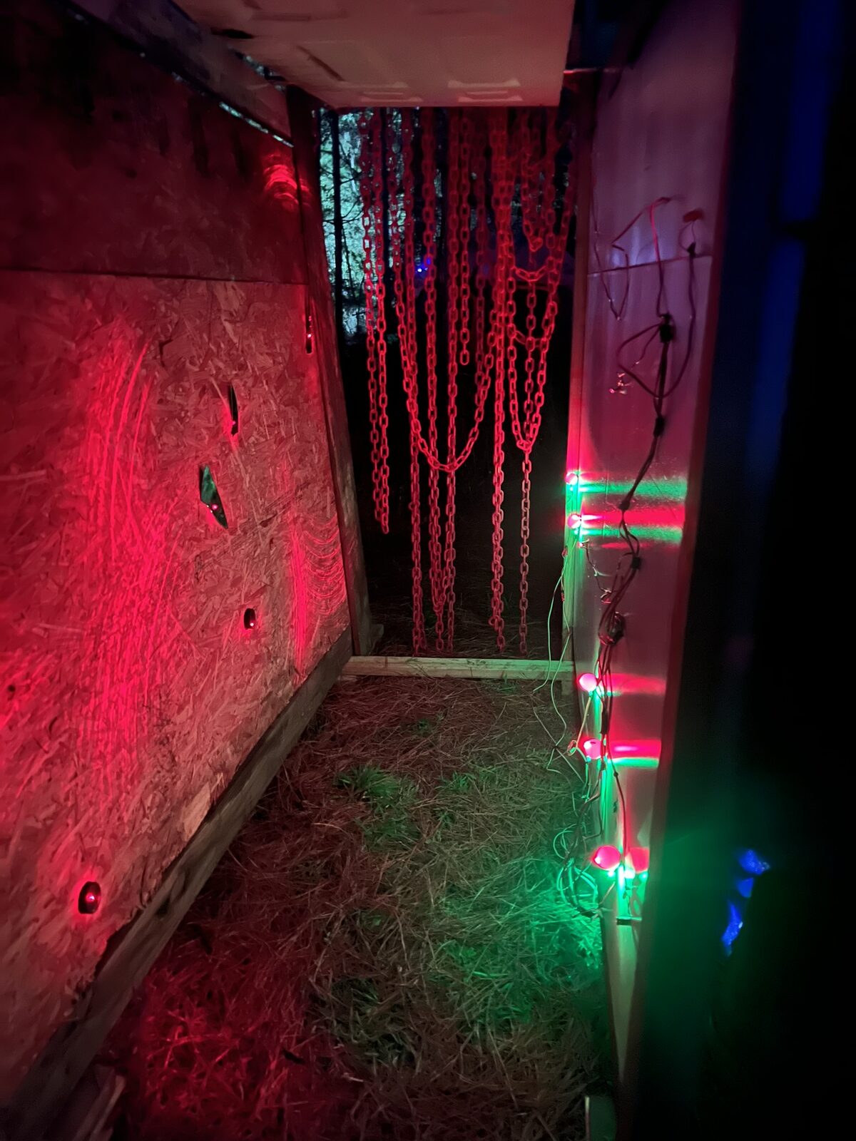 The Lazer Maze live at Engulf festival — fog-lit red beams crossing a narrow styrofoam-lined hallway